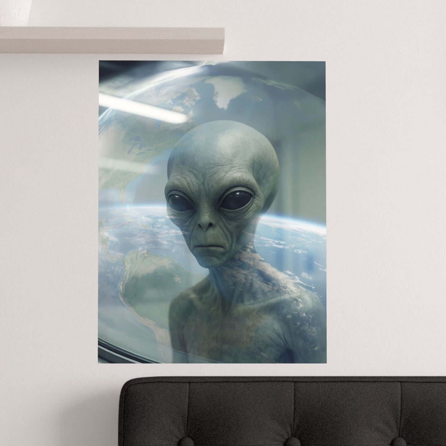 Poster of an alien on a wall above a bed
