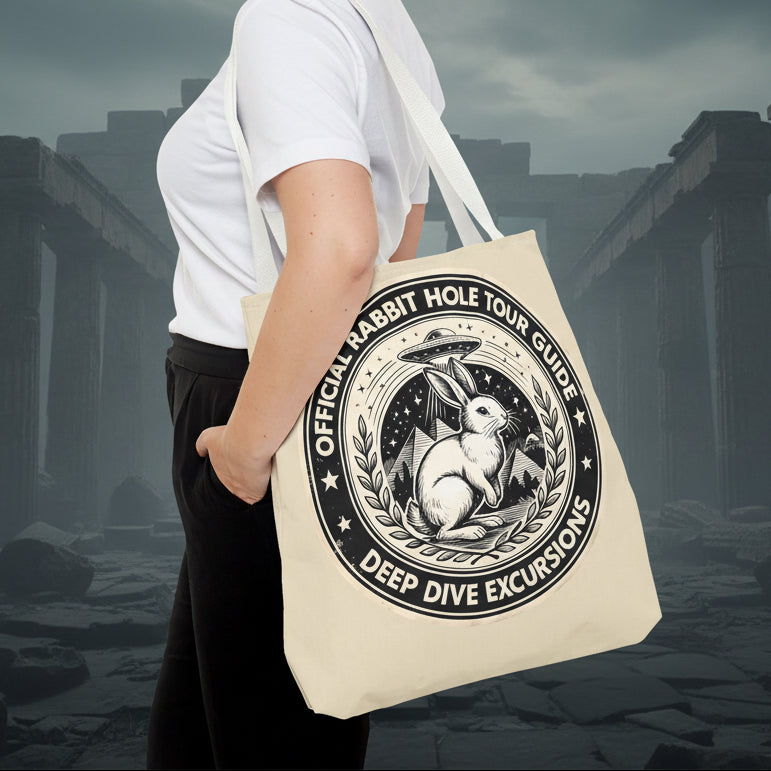 Person holding a tote bag with a rabbit design and text on a white background