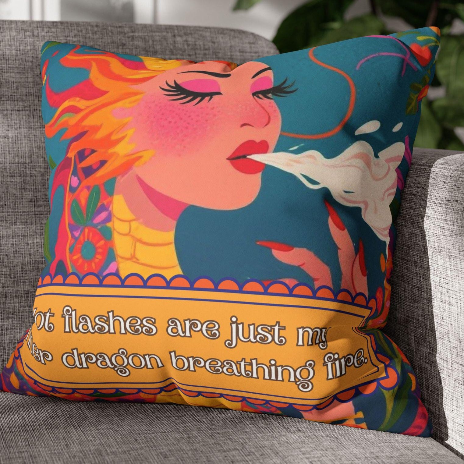 Colorful pillow with a dragon design on a gray couch