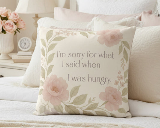 Decorative pillow with floral design and humorous text on a white background