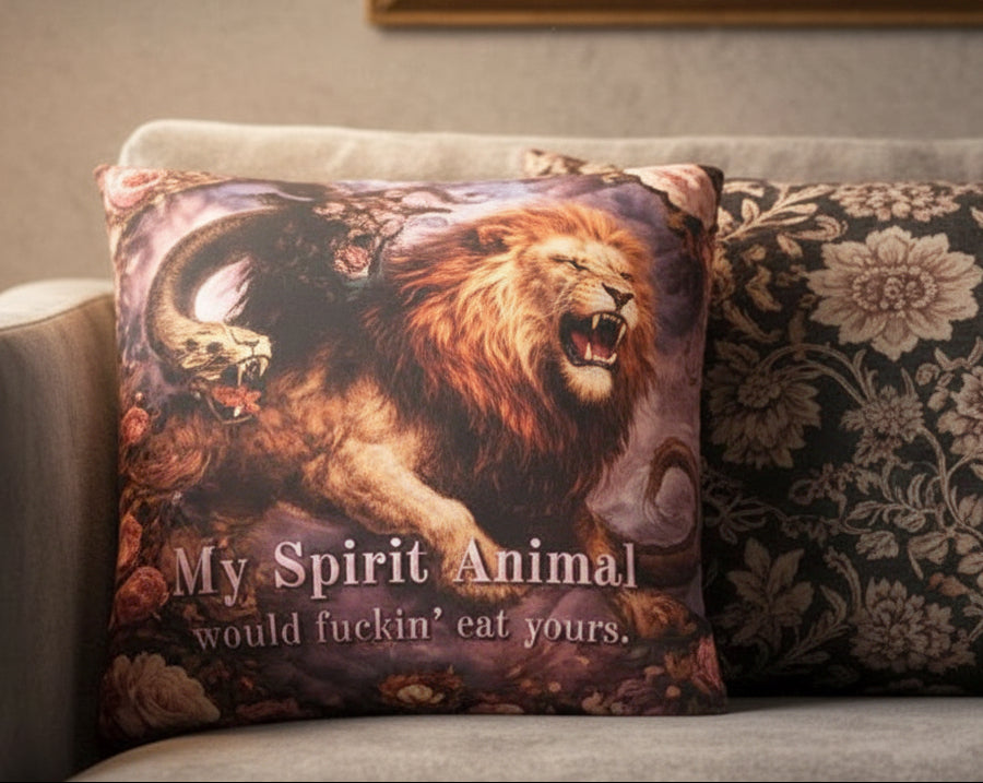 Gray sofa with decorative pillows, including one with a lion design and text.