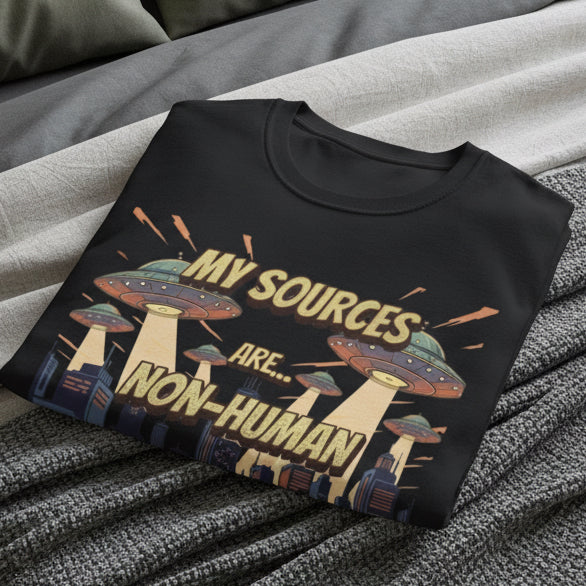 Black t-shirt with UFO design and text 'My sources are... non-human' on a white background