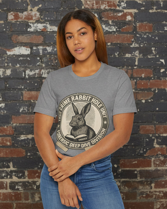 Woman wearing a gray t-shirt with a graphic design on a white background