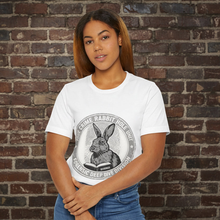 Woman wearing a true crime white t-shirt with a graphic design on a brickwall background